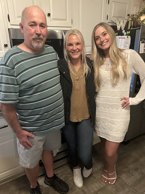 Roger with his daughters in the kitchen at home
