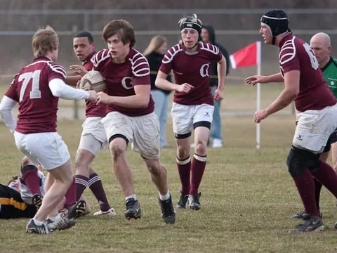 A Grandville rugby player carrying the ball upfield