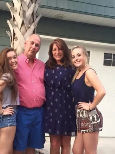 Roger with his family in the driveway at home