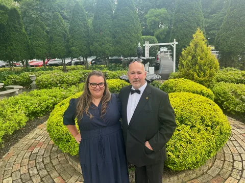 Roger and his wife in the garden before a wedding