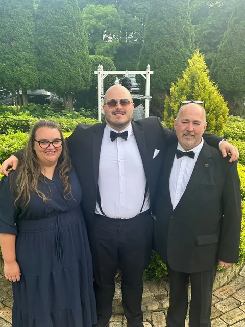 Roger with family at a wedding reception